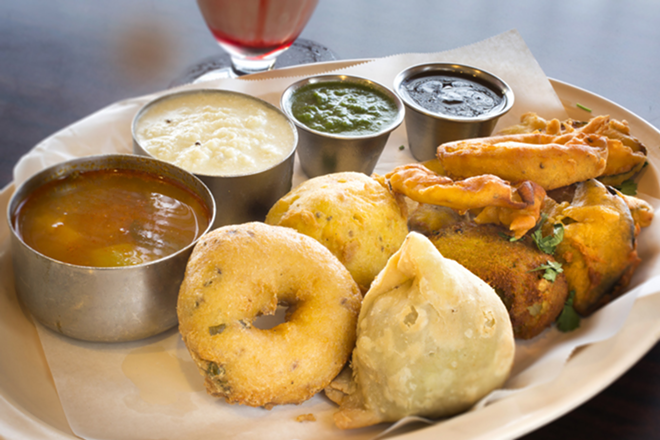 The appetizer platter includes medu vada, potato bonda and veggie samosa. - Chip Weiner