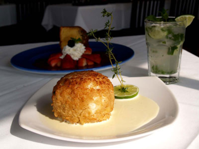 RUM AND CRAB IT: Oustanding crab cake (front) and rum cake at Crazy Conch Café. - Valerie Troyano