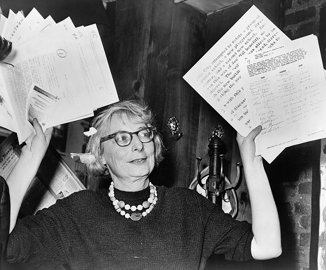 Jacobs holds up documentary evidence at a 1961 press conference during her crusade to save the West Village. - New York World-Telegram and the Sun Newspaper Photograph Collection, Library of Congress