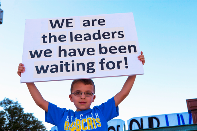 A boy holds a sign at Tampa March for our Lives. - Kimberly DeFalco