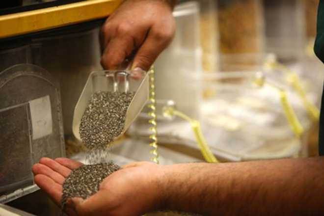 Rollin' Oats' associate Alain Del Rio displays organic bulk chia seed. - Kimberly DeFalco