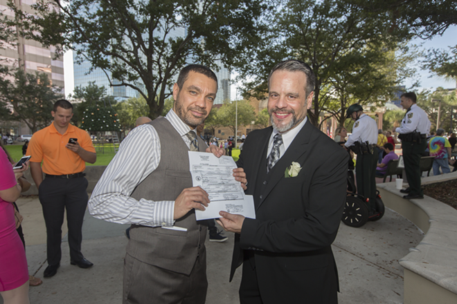 José Torres  and Marcelino Velez have been together for nine years. They participated in both a private marriage ceremony inside the clerk’s office as well as the mass ceremony outside. “Just to be sure," according to Velez. - Chip Weiner