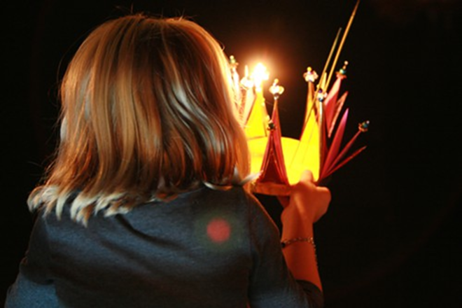 A small girl makes a wish before launching her krathong on the Palm River - Kimberly DeFalco