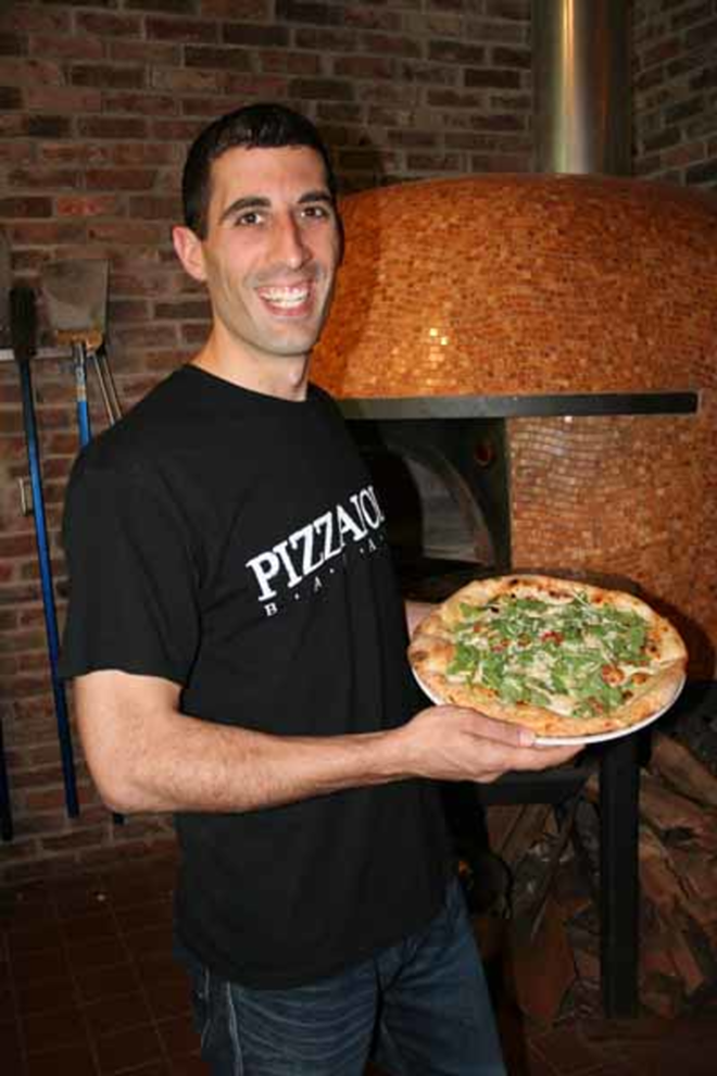 NICE PIE: Owner Dan Bavaro proudly shows off a 12-inch arugula pizza. - Eric Snider