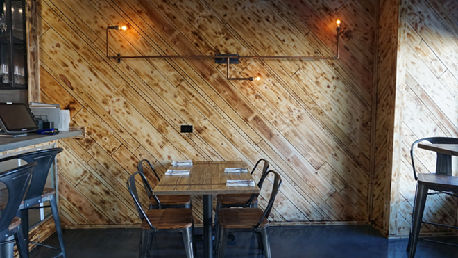 Renew created burn marks in the wood as a stylistic touch. Featuring steel and copper hardware, the gastropub's mixed metals are also essential. - Shelbi Hayes
