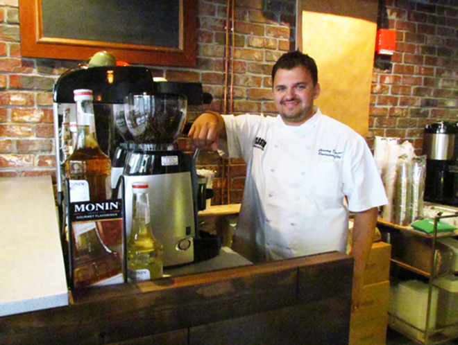 Co-owner Jeremy Duclut behind The Wooden Rooster’s coffee bar. - Andrea Bailey