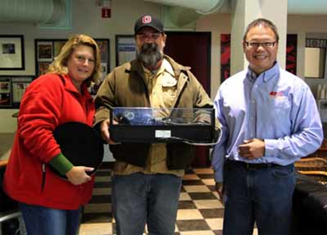 TURN, TURN, TURN: The winner, his wife and George Liu of Audio Visons South with the prize turntable. - Phil Bardi