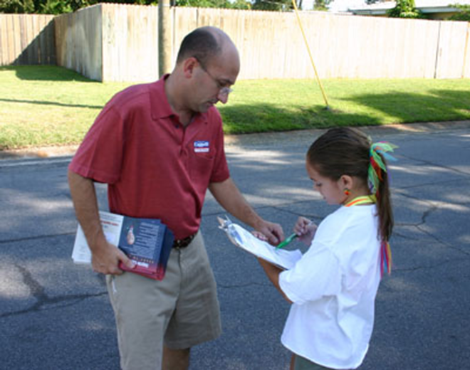 ALL IN THE FAMILY: Angelo Cappelli and daughter Anna take a break during door-to-door canvassing in St. Pete. - Phil Bardi