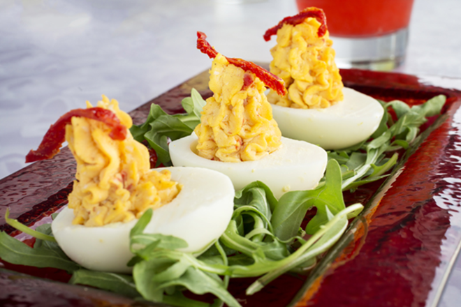 The deviled eggs showcase goat cheese and a sun-dried tomato garnish. - Chip Weiner