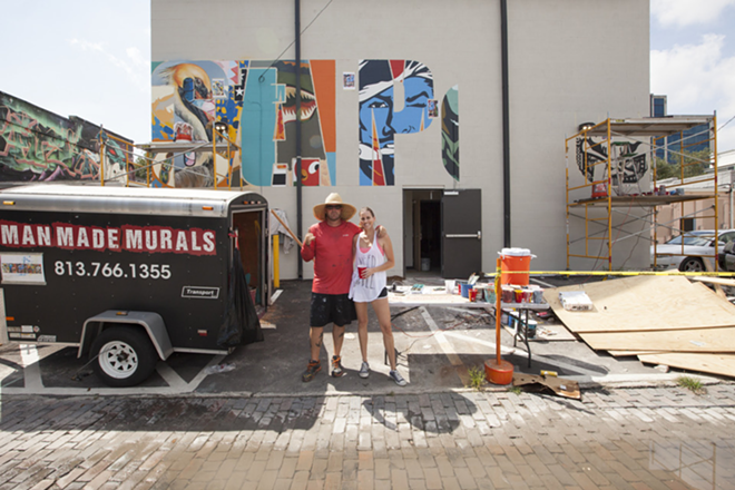 Matt Callahan of Manmade Murals and Angela Delaplane of Delaplane Studios stop for a quick chat in front of their St. Petersburg mural in progress in 2015. - Nicole Abbett