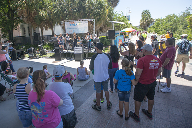 Music lovers watch student musicians on one of the several stages set up along the RiverWalk. - CHIP WEINER