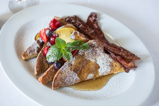 Ocean Prime's holiday French toast — fresh mixed berries, lemon curd, candied bacon and maple syrup. - Ocean Prime