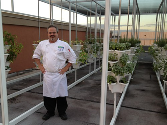 Chef Brett Gardiner in front of Pelagia Trattoria's rooftop garden. - ARIELLE STEVENSON