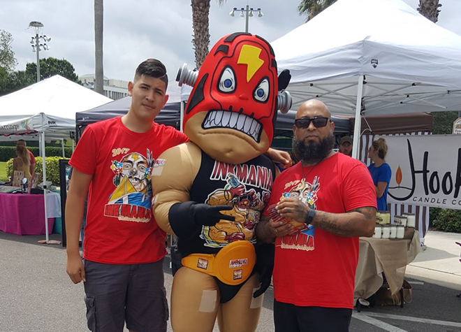 Stigma Ink owner Chino Gonzalez (R) with his son and Ink Mania's mascot. - COURTESY CHINO GONZALEZ