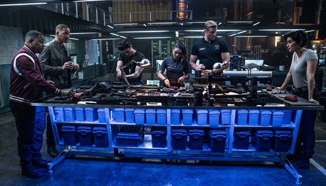 We need all the guns! Mike and Marcus look on as, from left, Rafe, Kelly, Dorn and Rita prepare an arsenal. - Ben Rothstein/Sony Pictures Entertainment