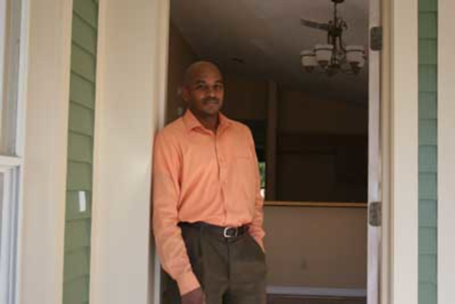 PIONEERING: Jerel McCants stands in the doorway of the InTown Homes model that he is buying, the first customer for the innovative project. - Wayne Garcia
