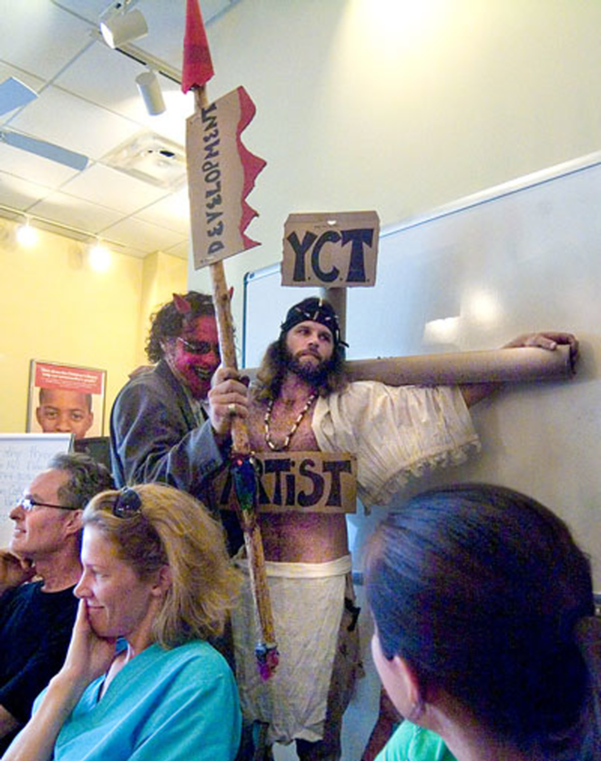 PROTEST: At a recent Historic Ybor Neighborhood Civic Association meeting, Blake Emory (Satan) stabs James Courtney (Jesus, representing the arts) with the "spear of development" to protest a proposal for the Oliva Cigar Factory. - Courtesy Of Blake Emory