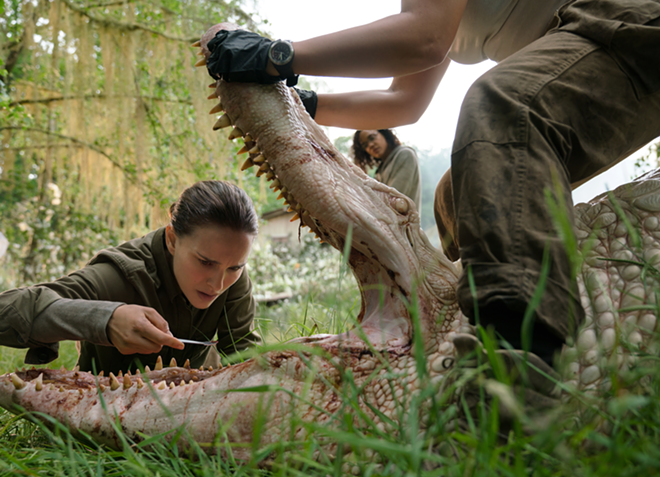Natalie Portman examines a mutated albino alligator after it attacks her team in Annihilation. - Paramount Pictures and Skydance