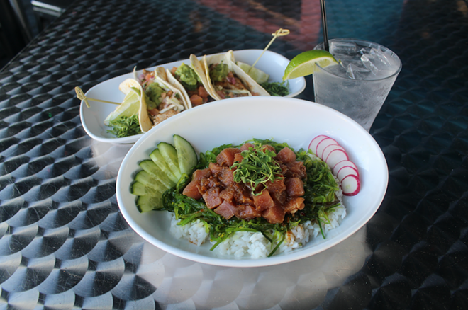 Old School Bar and Grill's poke bowl has a mound of fresh tuna cubes upon sticky rice surrounded by thin slices of cucumber and radish topped with crispy wontons. - Jenna Rimensnyder