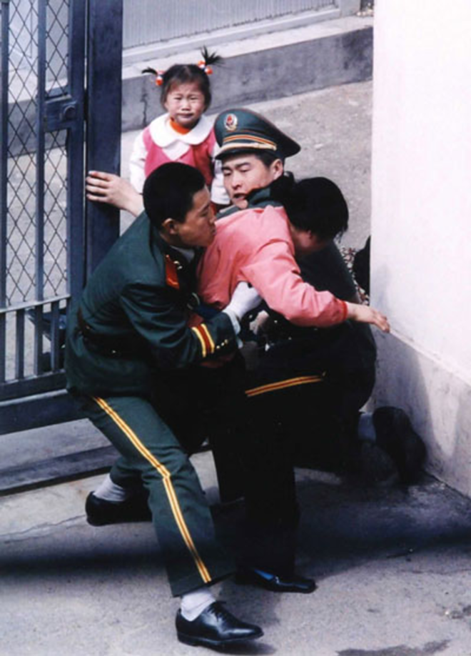 In Seoul Train, two-year-old Han-mi and her mother are aggressively accosted by Chinese guards at the Japanese Consulate in Shenyang, China. - Incite Productions