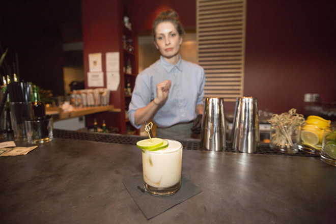 Behind the bar, Jessie Wohlers mixes shōchū cocktails, including Hero Water. - Chip Weiner