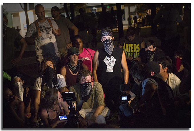 Protesters give accounts of police brutality during their demonstration in gaslight Park Wednesday night - Chip Weiner