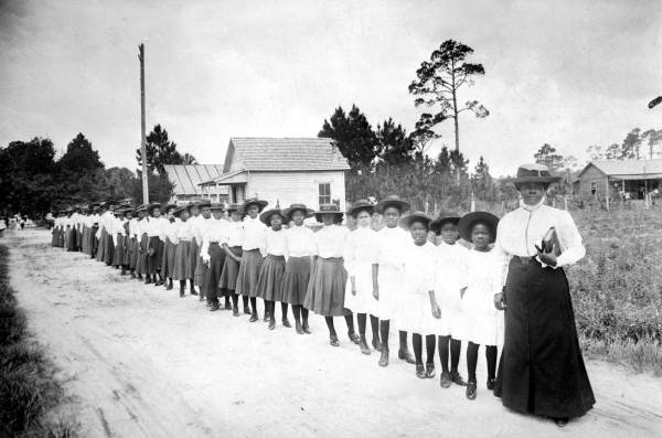 Mary McLeod Bethune, pictured here with students, was a trailblazer for education and civil rights in Florida. - Public Domain Photo