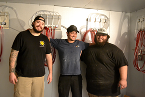 Founders Cary Lamb, Andrew Buckenham and Lucas Rizor inside their beer cooler. - Ryan Ballogg