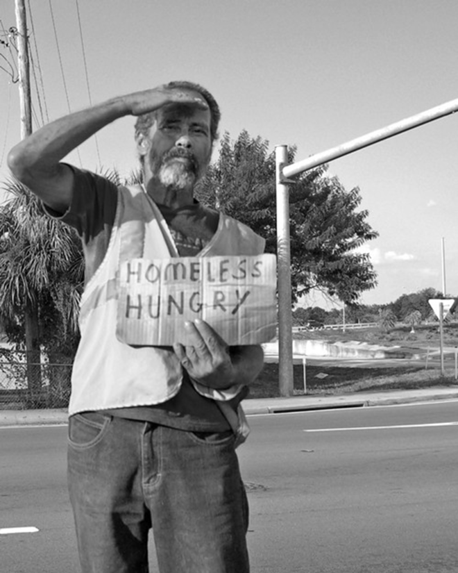 A homeless man asks for help on a hot summer day. - Lydia Harvey