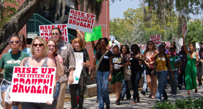 BUDGET AX SWINGS: Supporters of the Women's Studies and Africana Studies departments at the University of South Florida recently marched on campus to protest plans to merge the two fields. - Cara Trump