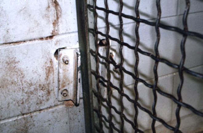 RUSTED: Former zookeeper Czarnik took this photo in June, 2006 of the warped latch on a gate leading to the "night house" that confined the tiger Enshalla. Czarnik told his supervisors the latch was difficult to close. - BRIAN CZARNIK