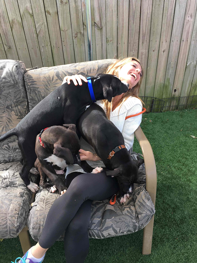 Suncoast Animal League volunteer dog walker Katie Mleczko accepts her payment. - Ernie Webb