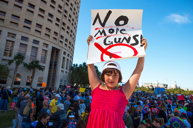 A girl holds a sign at Tampa March for our Lives. - Kimberly DeFalco