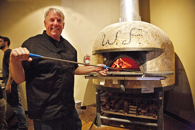 THE PEEL DEAL: Taylor mans the pizza peel at the Wood Fired oven in St. Pete. - Shanna Gillette