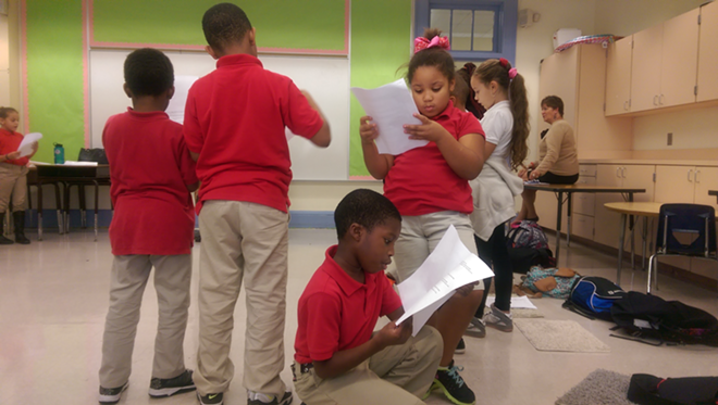 LINE READING: Students at B.C. Graham Elementary go over their scripts for a Patel Troupe holiday show. - Julie Garisto