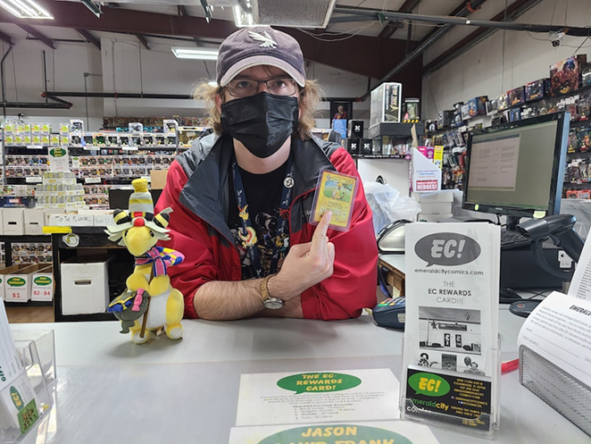 Andrew Barrow, 22, shows off his favorite Pokémon, Ampharos, in card and plush form while working at Emerald City Comics in Clearwater. - c/o Andrew Barrow
