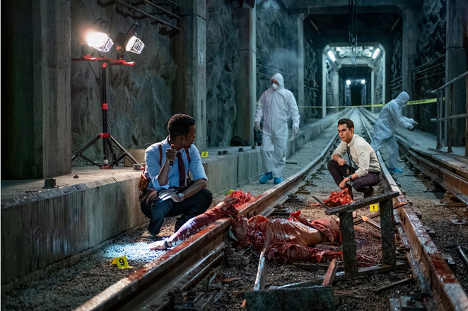Det. Zeke Banks (Chris Rock, left) and Det. William Schenk (Max Minghella) investigate a gory crime scene in "Spiral: From the Book of Saw" - Brooke Palmer/Lionsgate