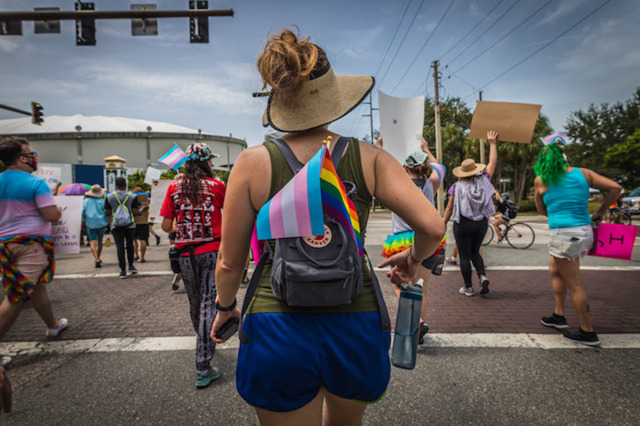 A protester marches with the trans and pride flag in St. Petersburg, Florida on June 28, 2020. - PHOTO BY DAVE DECKER