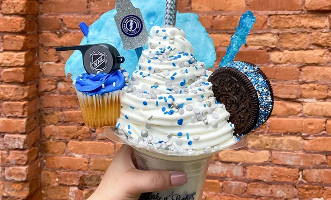 The NHL-themed vanilla ice cream is all about the blue; it’s got a vanilla cupcake topped with an NHL whistle, a Tampa Bay lightning silver glittering cup, blue cotton candy and an oreo ice cream sandwich dotted with blue sprinkles. - Photo via Bake'n Babes/Instargam