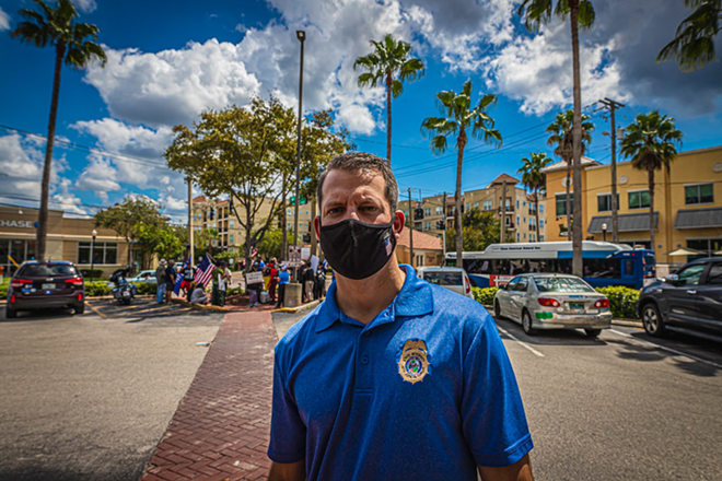 State Attorney Andrew Warren observes a protest and counter protest outside a CVS in Tampa, Florida on Sept. 19, 2020. - Dave Decker