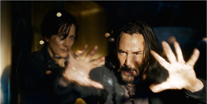 Neo (Keanu Reeves, right) and Trinity (Carrie-Anne Moss) return after 18 years so fans can discover their fate in "The Matrix Resurrections" - WARNER BROS. PICTURES