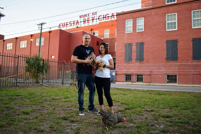 Dylan Breese (L) and Anahy Gutierrez with a few chicken rescues in front of the JC Newman Cigar Company. - Justin Garcia