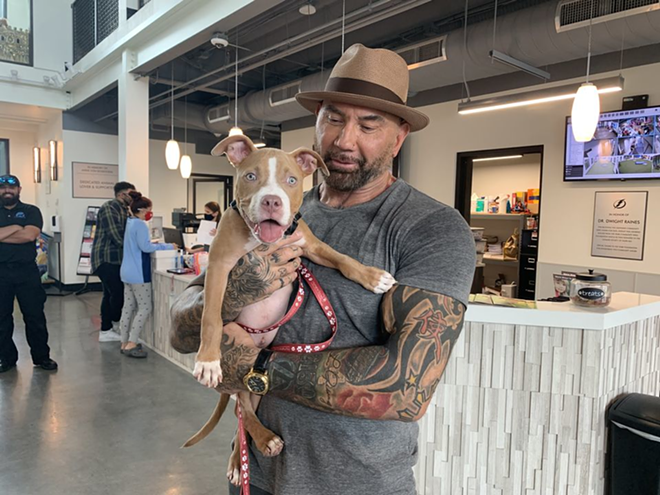 Bautista with “Penny,” who was found with a metal chain embedded into her neck and chin. - PHOTO VIA THE HUMANE SOCIETY OF TAMPA BAY/FACEBOOK