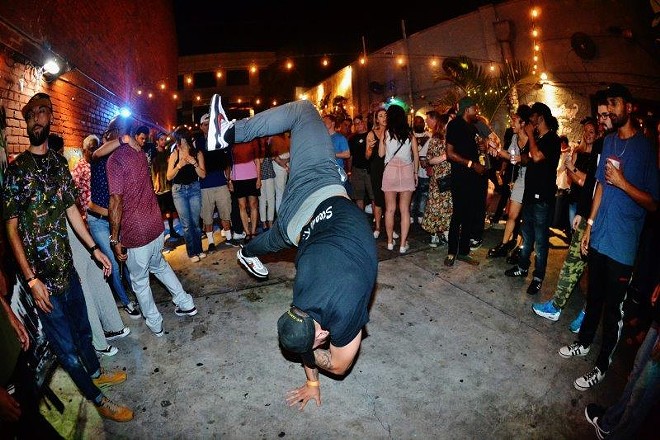 A dancer and crowd during a 'Ol' Dirty Sunday' at Crowbar in Ybor City, Florida. - BRIAN MAHAR