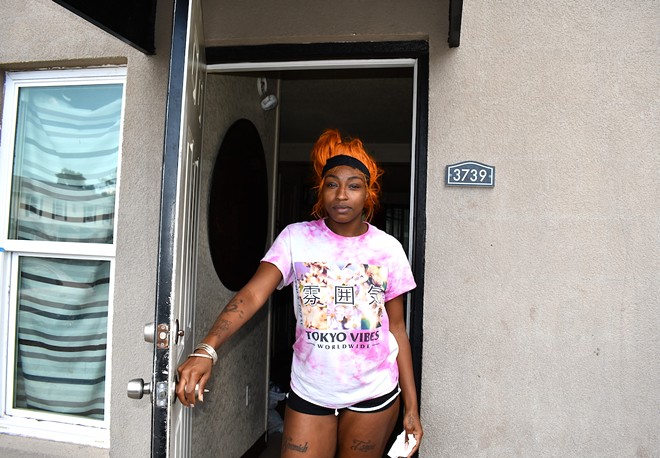 Nngozi Evans standing outside of her apartment at Jackson Heights Apartments. - Justin Garcia