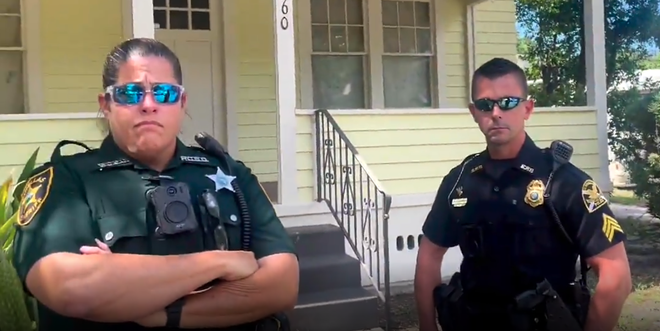 A screenshot from a video taken by St. Petersburg Tenants Union shows law enforcement officers who attempted illegal eviction. - St. Petersburg Tenants Union