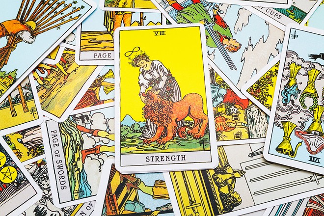 The Strength card is often a woman holding open the mouth of a lion.