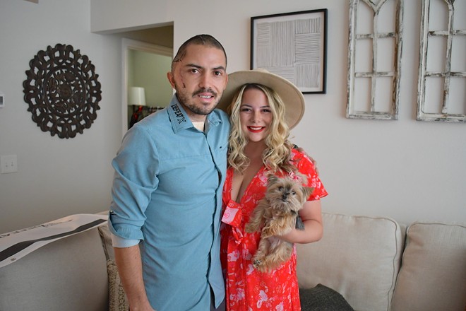 Juan Carlos La Verde poses with his wife, Christine, inside their living room. - Justin Garcia