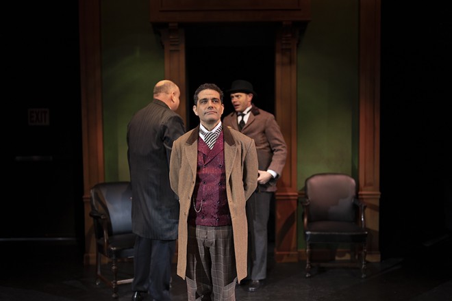 Embodying the supremely cool and cerebral Sherlock Holmes, Davis returns to the stage while also directing the madcap action with perfect panache. - Photo by Thee Photo Ninja