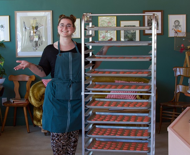 Yelvington poses with hundreds of macarons inside of her V.M. Ybor bakery. - c/o Elevenses